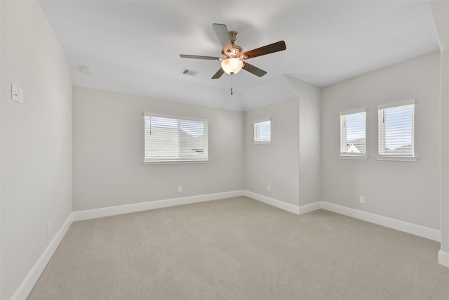 unfurnished room with ceiling fan, baseboards, visible vents, and light carpet