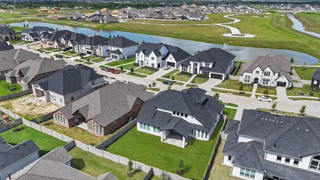 bird's eye view with a residential view and a water view
