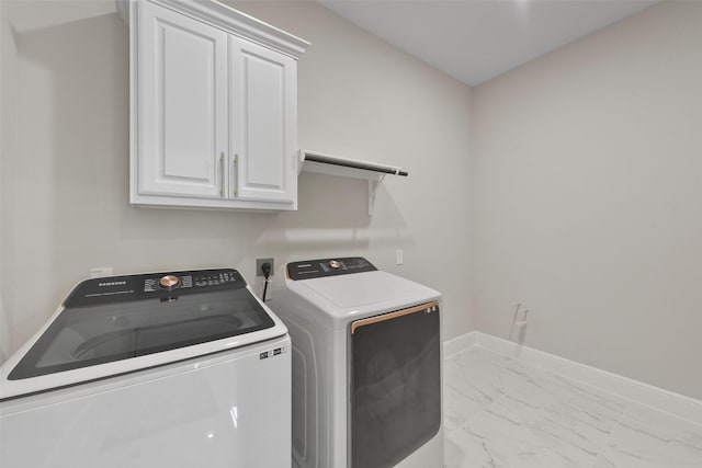 laundry area with cabinet space, marble finish floor, independent washer and dryer, and baseboards