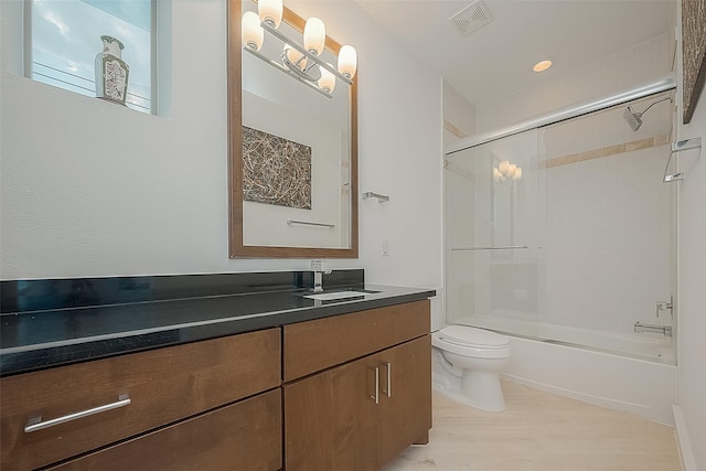 6110 Potomac Enclave Dr, Houston, TX 77057 - full bathroom with toilet, wood finished floors, vanity, and shower / washtub combination