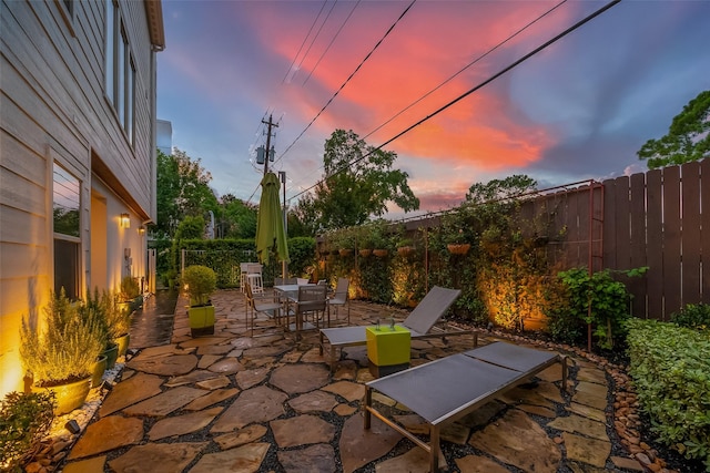 6110 Potomac Enclave Dr, Houston, TX 77057 - patio terrace at dusk featuring a fenced backyard and outdoor dining area