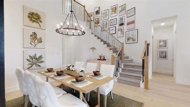 12043 Lake View Blvd, Mont Belvieu, TX 77523 - dining space with stairs, a high ceiling, light wood-style flooring, and a chandelier