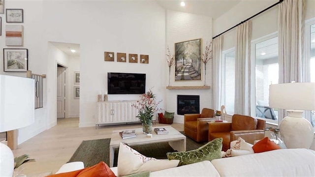 12043 Lake View Blvd, Mont Belvieu, TX 77523 - living area featuring a high ceiling, wood finished floors, a large fireplace, and recessed lighting