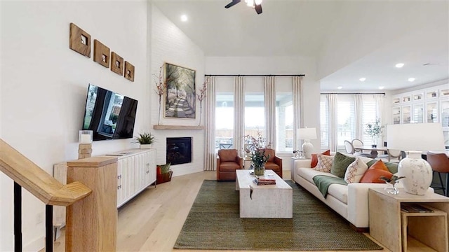 12043 Lake View Blvd, Mont Belvieu, TX 77523 - living room with a glass covered fireplace, recessed lighting, ceiling fan, and light wood-style floors