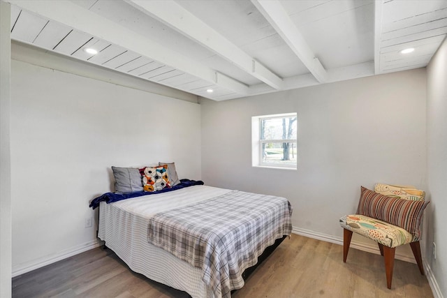bedroom with beam ceiling, recessed lighting, wood finished floors, and baseboards