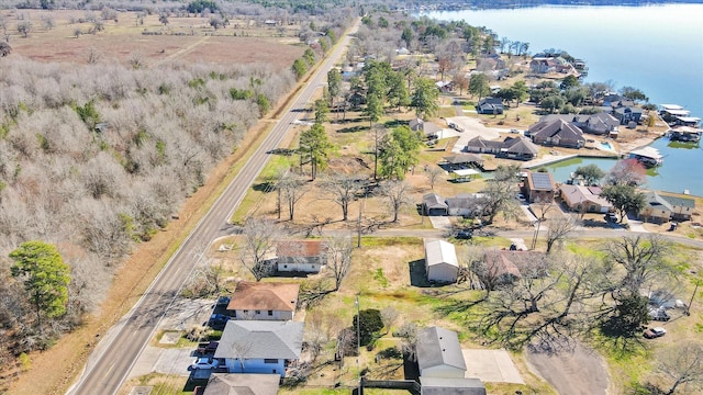 drone / aerial view featuring a residential view and a water view