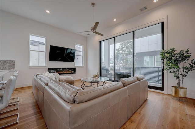 2414 Canal St Unit A, Houston, TX 77003 - living room featuring light wood-style flooring, baseboards, ceiling fan, and recessed lighting
