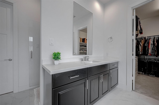 2414 Canal St Unit A, Houston, TX 77003 - bathroom with marble look tile flooring, a spacious closet, and vanity