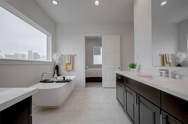 2414 Canal St Unit A, Houston, TX 77003 - full bathroom with healthy amount of natural light, marble finish floors, recessed lighting, a freestanding bath, and vanity