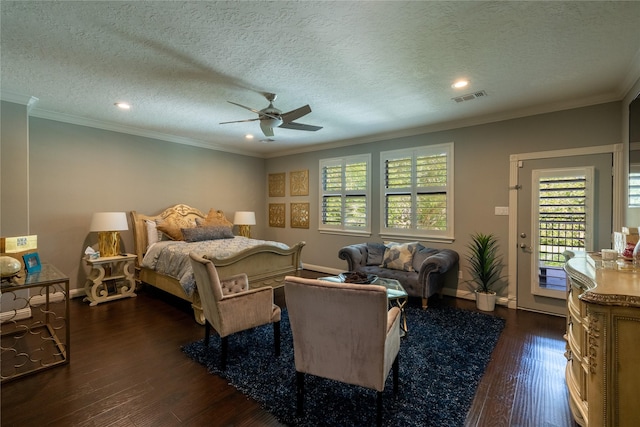 bedroom with dark wood-style floors, visible vents, ceiling fan, and ornamental molding