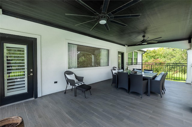deck with outdoor dining area and ceiling fan