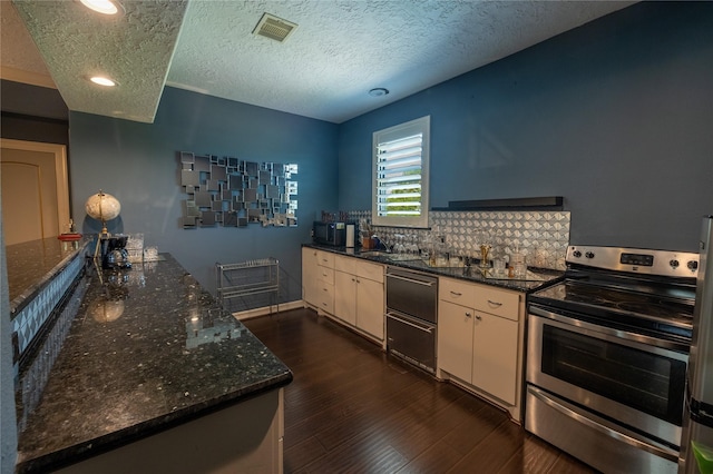 kitchen with tasteful backsplash, visible vents, dark stone countertops, electric range, and dark wood-style flooring