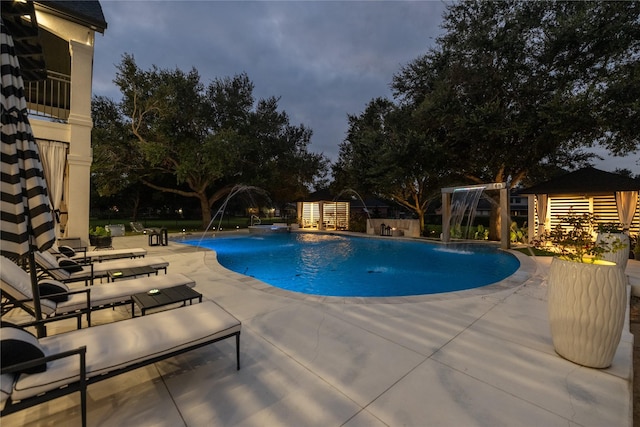 outdoor pool with a patio and fence