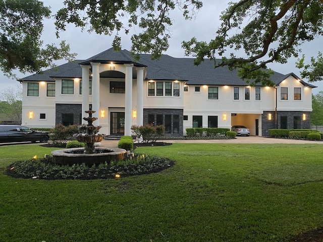 view of front facade featuring stone siding and stucco siding