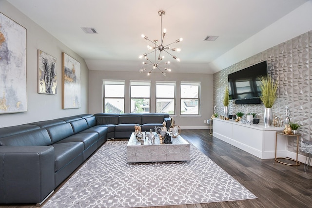 living area featuring visible vents, baseboards, an inviting chandelier, and dark wood-style flooring