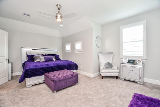 bedroom featuring visible vents, lofted ceiling, a ceiling fan, baseboards, and light colored carpet