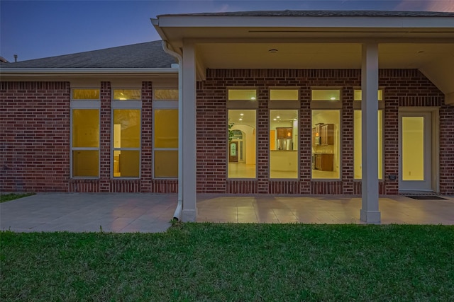 6010 Le Moyne Pass Ln, Missouri City, TX 77459 - entrance to property with a patio, a yard, and brick siding