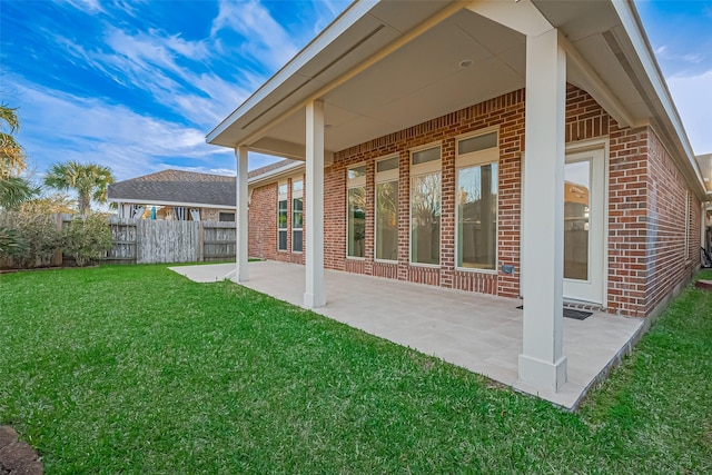 6010 Le Moyne Pass Ln, Missouri City, TX 77459 - rear view of house with a yard, a patio, brick siding, and fence