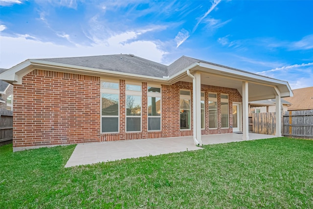 6010 Le Moyne Pass Ln, Missouri City, TX 77459 - back of house featuring brick siding, a patio area, fence, and a lawn