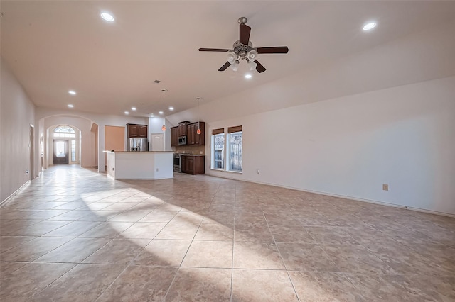 6010 Le Moyne Pass Ln, Missouri City, TX 77459 - unfurnished living room with arched walkways, recessed lighting, a wealth of natural light, and a ceiling fan