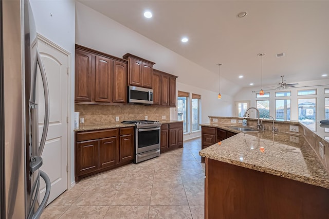 6010 Le Moyne Pass Ln, Missouri City, TX 77459 - kitchen with visible vents, lofted ceiling, decorative backsplash, appliances with stainless steel finishes, and a sink