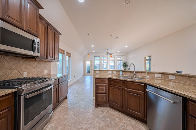 6010 Le Moyne Pass Ln, Missouri City, TX 77459 - kitchen featuring a ceiling fan, a sink, light stone counters, appliances with stainless steel finishes, and decorative backsplash