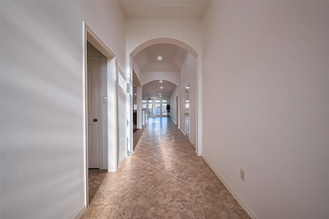 6010 Le Moyne Pass Ln, Missouri City, TX 77459 - hall featuring light tile patterned floors, baseboards, and arched walkways
