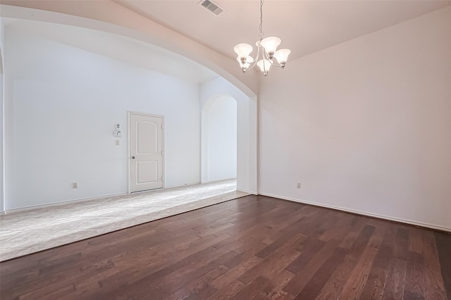 6010 Le Moyne Pass Ln, Missouri City, TX 77459 - empty room featuring visible vents, arched walkways, a notable chandelier, and wood finished floors
