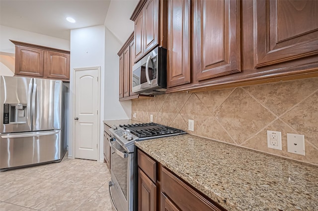 6010 Le Moyne Pass Ln, Missouri City, TX 77459 - kitchen with light stone countertops, light tile patterned flooring, recessed lighting, appliances with stainless steel finishes, and backsplash