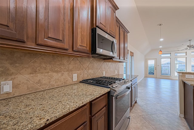 6010 Le Moyne Pass Ln, Missouri City, TX 77459 - kitchen featuring light stone counters, light tile patterned floors, stainless steel appliances, decorative backsplash, and vaulted ceiling