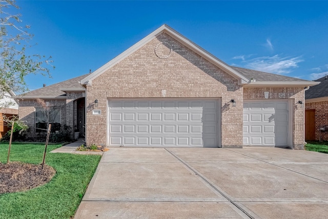 single story home featuring a garage, brick siding, and driveway