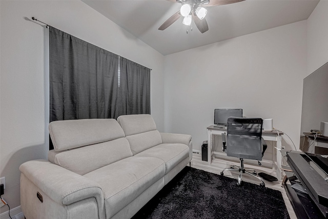 office space with baseboards and ceiling fan