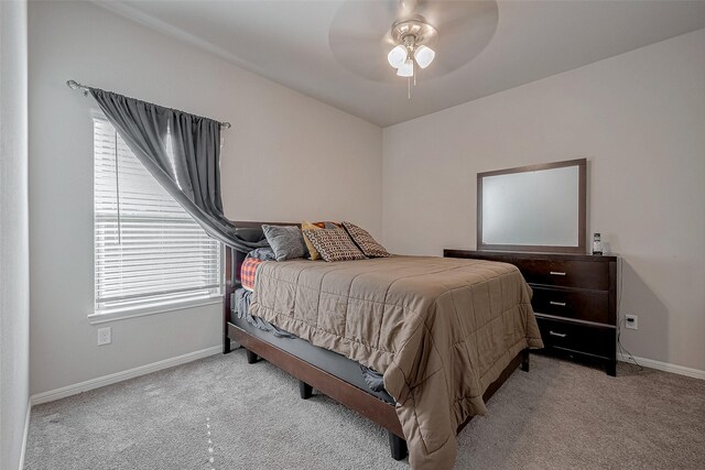 bedroom with baseboards, a ceiling fan, and carpet flooring