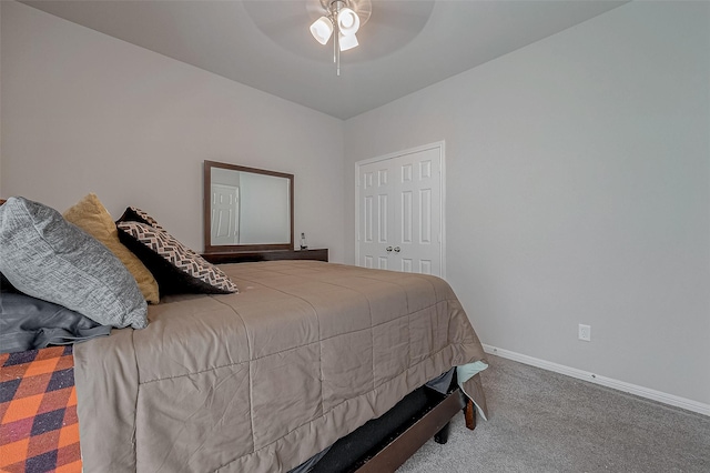 bedroom featuring a closet, baseboards, carpet, and a ceiling fan