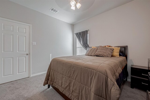 carpeted bedroom featuring a ceiling fan, baseboards, and visible vents