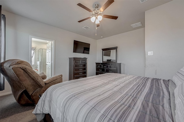 carpeted bedroom with visible vents, connected bathroom, and a ceiling fan