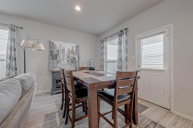 dining space with recessed lighting, baseboards, and light wood-style flooring