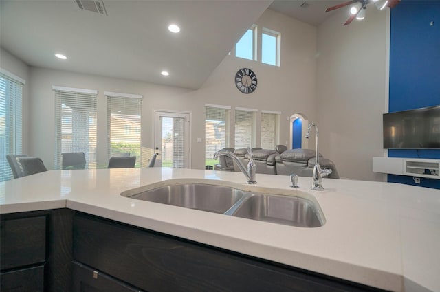 kitchen featuring visible vents, a sink, open floor plan, light countertops, and a healthy amount of sunlight