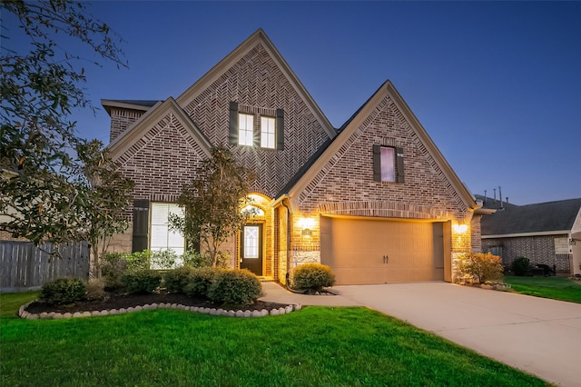view of front facade with brick siding, concrete driveway, a front yard, and a garage