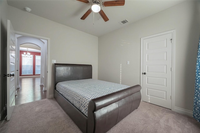 bedroom with visible vents, arched walkways, baseboards, and carpet flooring