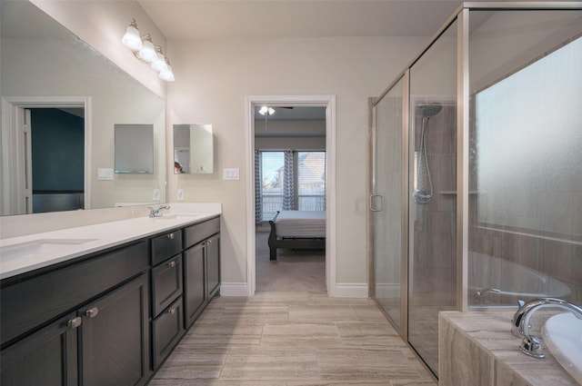 ensuite bathroom featuring a shower stall, double vanity, ensuite bathroom, and a sink