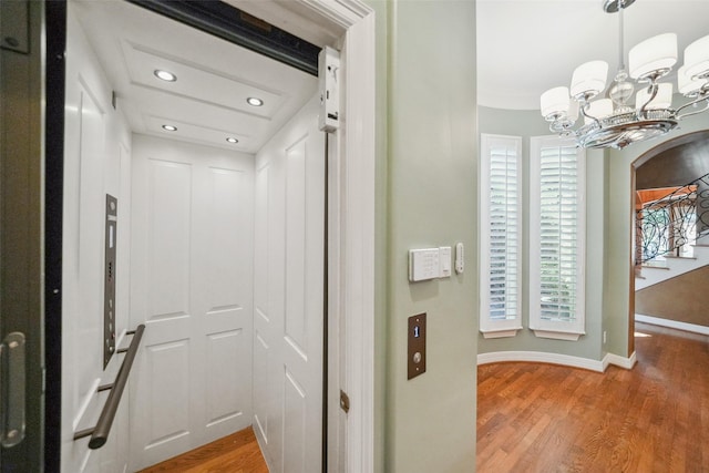 2112 Mcduffie St, Houston, TX 77019 - corridor with elevator, recessed lighting, a chandelier, light wood-type flooring, and baseboards