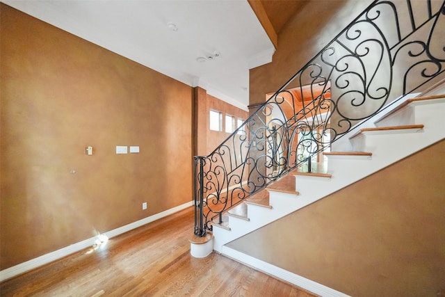 2112 Mcduffie St, Houston, TX 77019 - staircase featuring baseboards, wood finished floors, and crown molding
