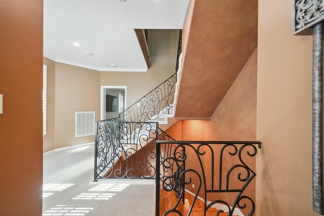 2112 Mcduffie St, Houston, TX 77019 - stairway with carpet floors, crown molding, and recessed lighting