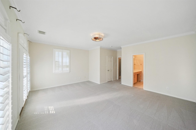 2112 Mcduffie St, Houston, TX 77019 - unfurnished bedroom with light carpet, baseboards, ornamental molding, and ensuite bath