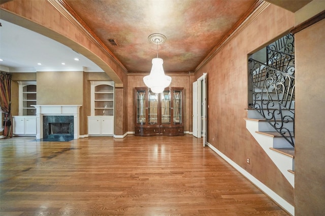 2112 Mcduffie St, Houston, TX 77019 - entrance foyer with crown molding, wood finished floors, stairway, baseboards, and arched walkways