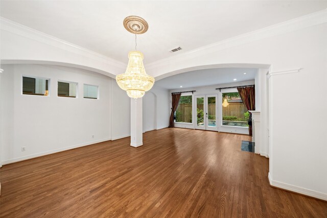2112 Mcduffie St, Houston, TX 77019 - unfurnished living room featuring a chandelier, wood finished floors, crown molding, and arched walkways
