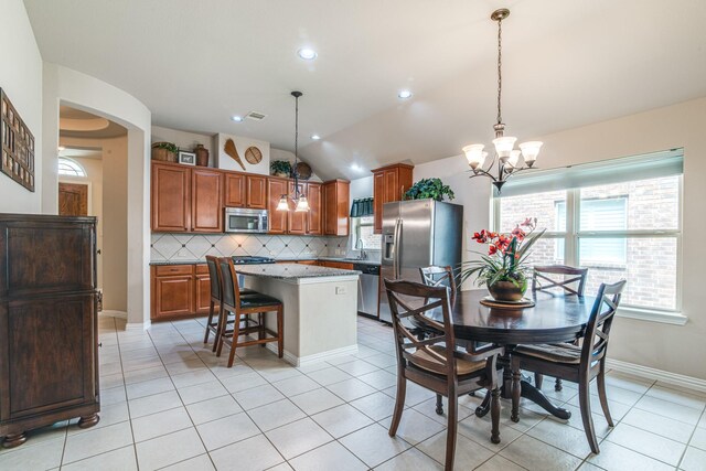 1415 Nacogdoches Valley Dr, League City, TX 77573 - dining space featuring light tile patterned floors, arched walkways, lofted ceiling, and an inviting chandelier