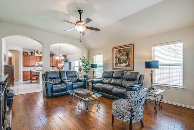 1415 Nacogdoches Valley Dr, League City, TX 77573 - living area featuring arched walkways, plenty of natural light, ceiling fan with notable chandelier, and hardwood / wood-style floors