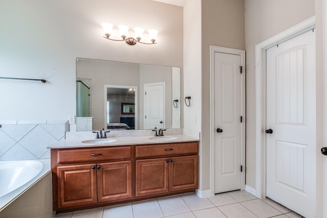 1415 Nacogdoches Valley Dr, League City, TX 77573 - full bathroom with double vanity, connected bathroom, a garden tub, and a sink